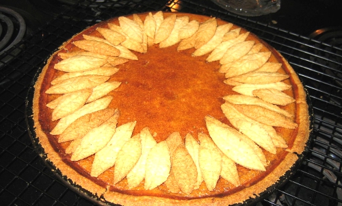 Pumpkin pie with pastry leaf decoration.