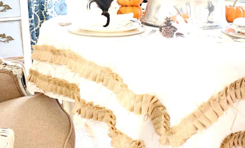 A Rustic Tablecloth With Ruffled Burlap Trim.