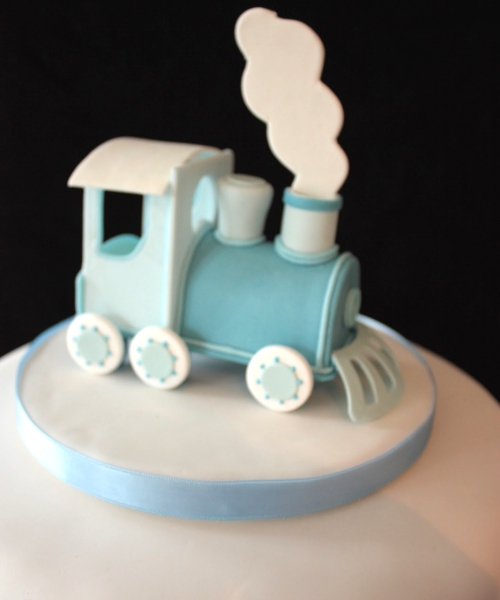 Christening cake with train topper.