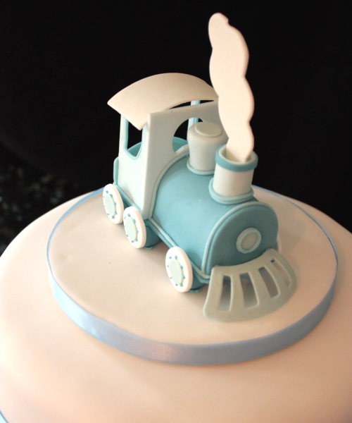 Christening cake with train topper.